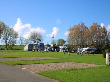 Hardstanding pitches with a play area in the middle (added by manager 12 jan 2024)