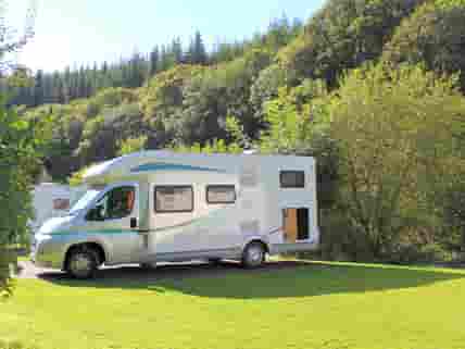 Large hardstanding pitches with grass area for motorhomes and caravans