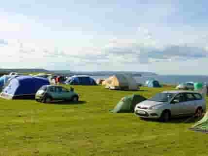 Large tent field with sea views. No set pitches so you choose where you go.
