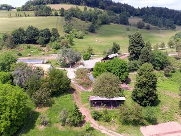 View of the site and the farmhouse, with a fruit orchard