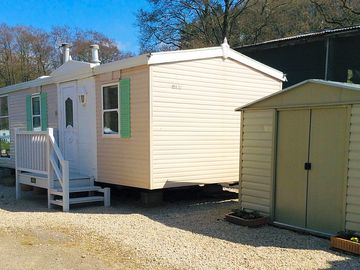 Outside the caravan, with parking space and storage shed (added by manager 08 May 2021)