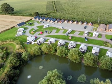 Aerial view of the pitches, the pods and one of the lakes on site (added by manager 02 Aug 2022)
