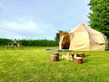 Bell tent, picnic table and firepit