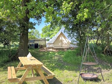Bell tent and exclusive picnic table and fire pit