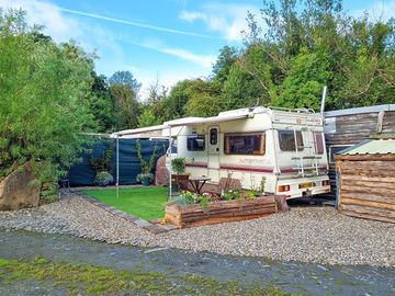 Caravan with a covered patio, plus table and chairs