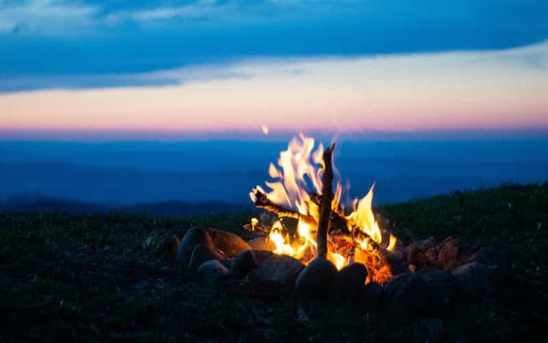 Cook over a campfire. Timon Wanner/Unsplash