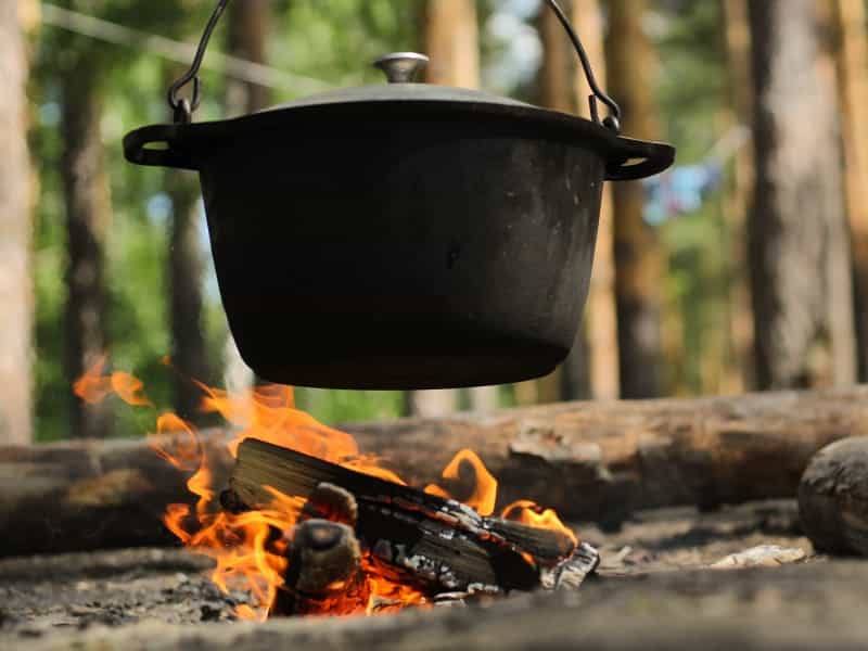 Hang a Dutch oven over your campfire for a delicious stew or chilli (Ignat Kushanrev / Unsplash)