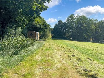 Shepherd's hut in a large field