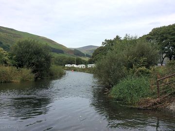 The river dysynni bordering the site
