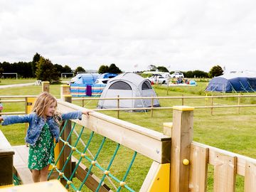 Grass tent and trailer tent pitch with electric and play area