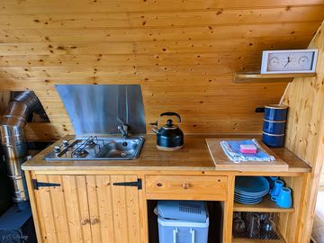Kitchen area. two ring gas hob. sink. cool box