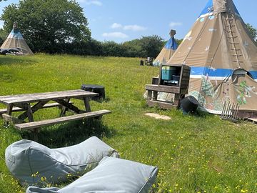 Large tipi with bean bags outside