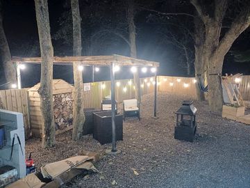 Fairy lights illuminate the site after dark