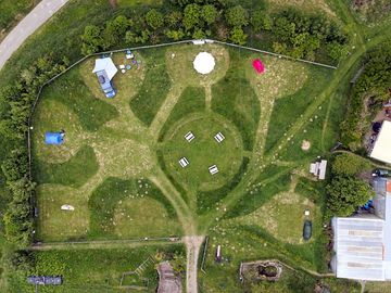 Birdseye view of the spacious main pitches surrounding the central shared areas with picnic benches
