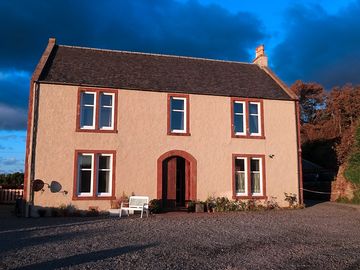 Muasdale house lite up by the sunset