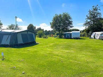 Spacious pitches with picnic tables and a play area