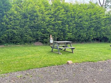 Grassy pitch with picnic table (added by manager 23 jun 2023)