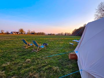 Bell tent with campfire and outdoor seating