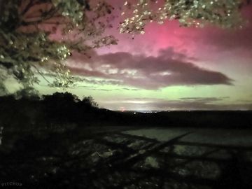 Views across to exmoor of the night sky showing the northern lights