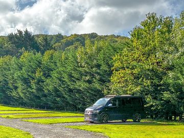 Grass and gravel campervan pitch.