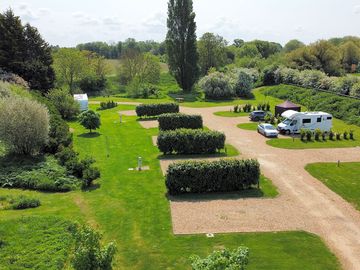 Aerial view of the pitches, showing privacy hedging and layout