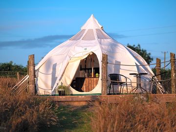 Luxury glamping bell tents, furnished with a comfortable double bed and various cosy amenities
