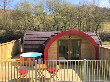Exterior photo showing the hot tub and decking