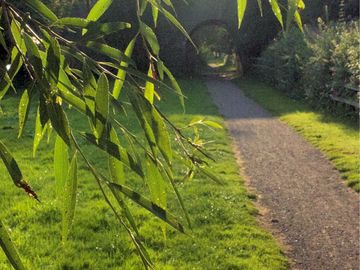 Public footpath or cycle route along the river going under the bridge
