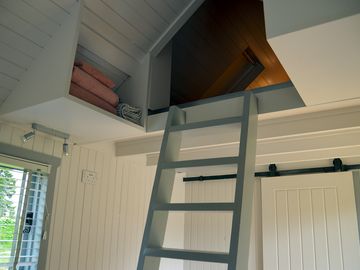 Hand-built ladders up to the mezzanine level with storage on either side (added by manager 23 jun 2022)