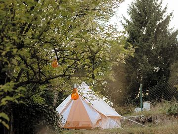 Bell tent surrounded by greenery
