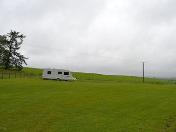 Pitch on the left beside woods and open fields