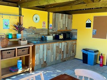 Shared kitchen area with fridge, dishwasher, toaster & microwave.