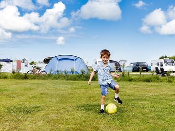 Touring pitch with electric hookup, and large recreational spaces