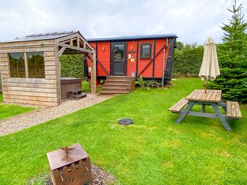 Space around the hut, with hot tub