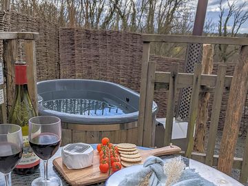 Outdoor area with seating and hot tub