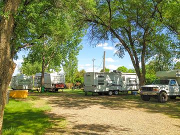 Tent pitch on the grass, rvs on the gravel