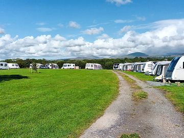 Site and pitches with a mountain backdrop