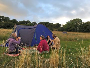 Visitors enjoying an evening on one of our tent pitches