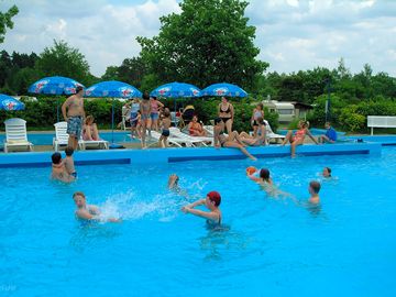Solar-heated outdoor swimming pool
