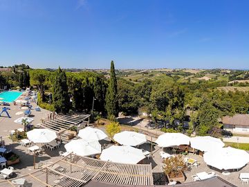 Restaurant's terrace near the swimming pool, with a beautiful view over the marche landscape