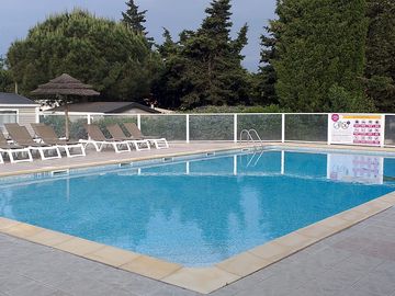 Outdoor pool with sun loungers
