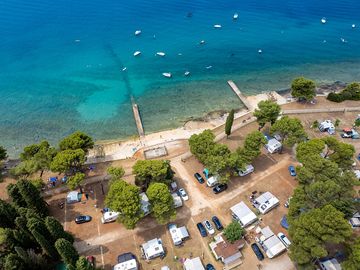 Enjoy the comfort of accommodation in the pine forest, olive grove shade, or right by the sea!