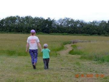 Strolling through the tent area towards one of the wildflower meadows