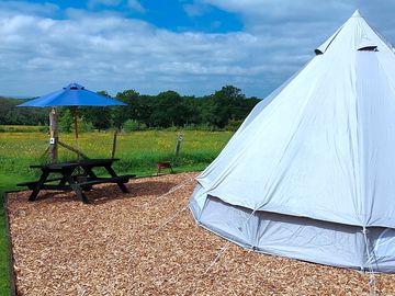 Bell tent exterior with picnic table