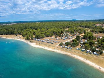 Enjoy the comfort of accommodation in the pine forest, olive grove shade, or right by the sea!