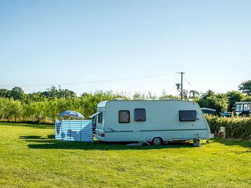 Touring caravan on an electric pitch