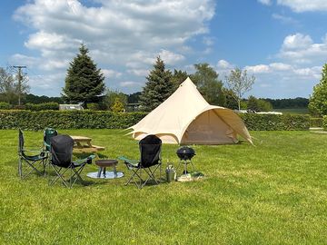 Six-metre bell tent with picnic bench, barbecue and camp chairs around the firepit (added by manager 14 mar 2022)
