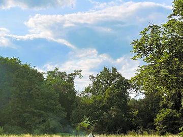 Robens pre-pitched bell tent viewed from the orchard.