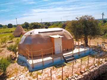 The dome is next to a trullo