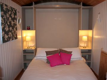 The very comfy bed pulled down by night